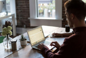 Man on laptop at a coffee shop