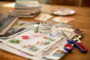 A table with crafting supplies, stickers, scissors and books