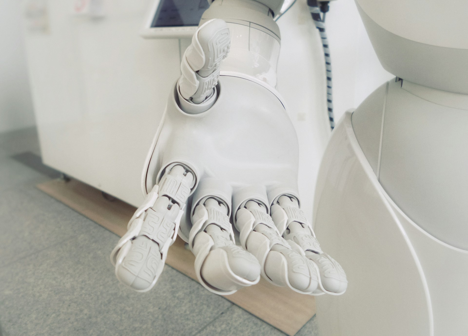 A robotic hand in front of a hospital, or therapy, setting