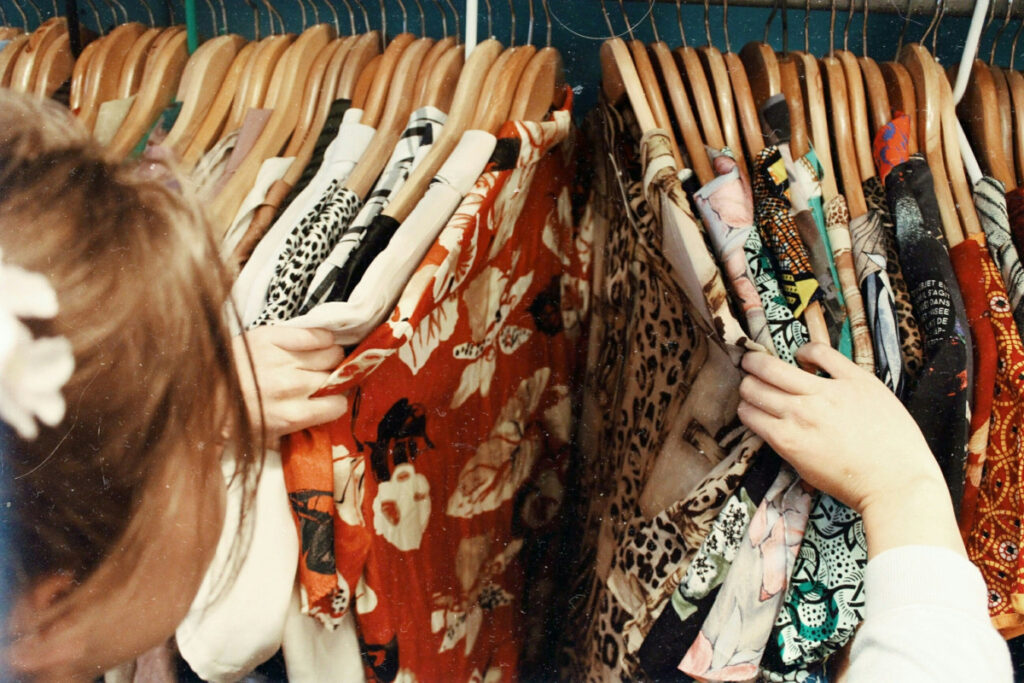 Person looking through clothes inside their closet